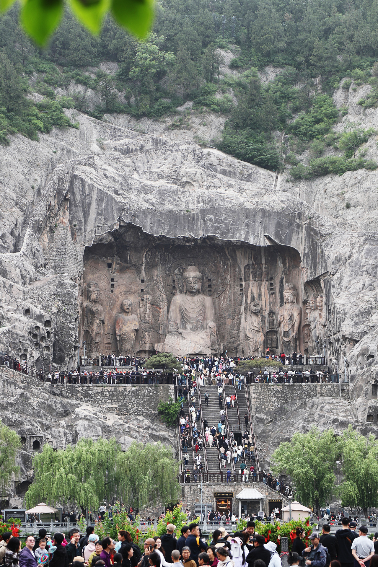 The Fengxian Temple and its statues are viewed from across the river at the Longmen Grottoes in Luoyang, Henan Province. /CGTN