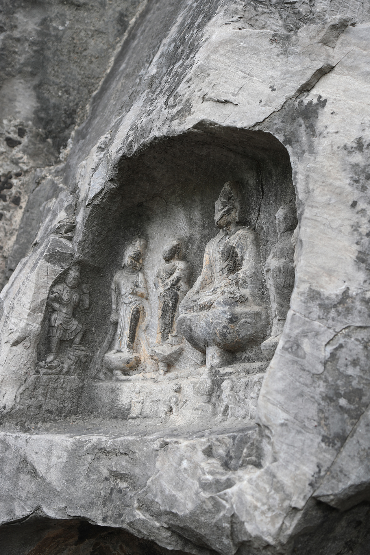 Small statues are seen in a niche at the Longmen Grottoes in Luoyang, Henan Province. /CGTN