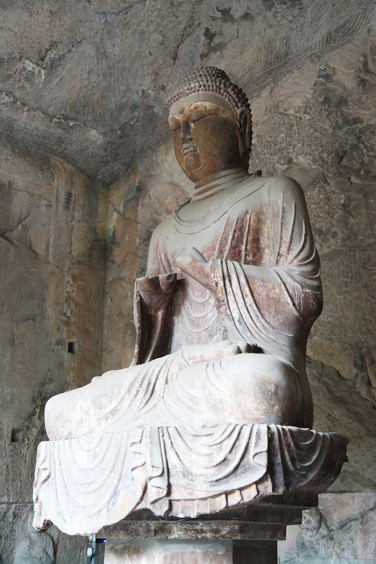 A statue is seen in a cave at the Longmen Grottoes in Luoyang, Henan Province. /CGTN