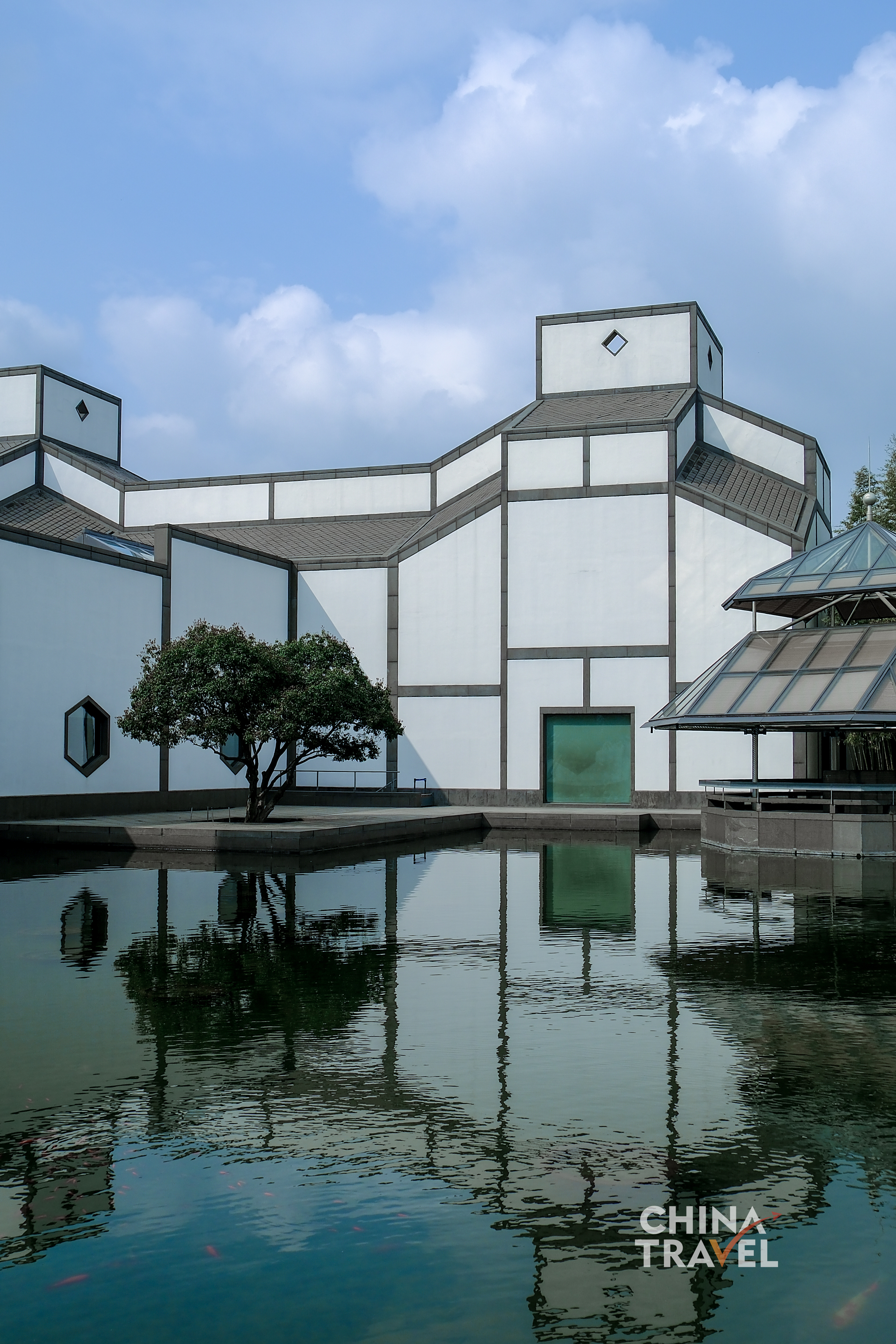 White walls and angular roofs meet still water, doubling the architecture in quiet, shifting reflections. /CGTN