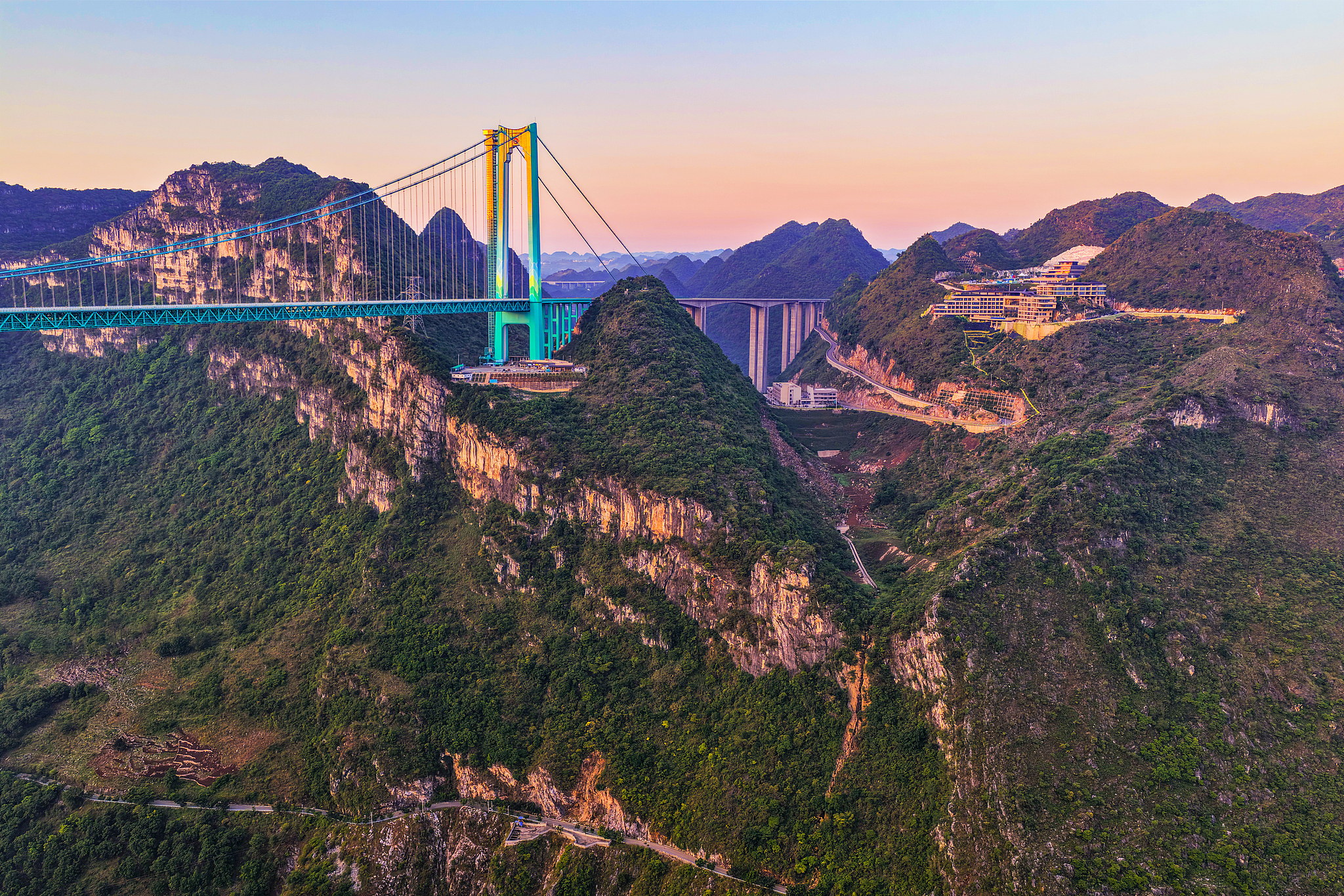 A photo taken on May 4, 2026 shows the Huajiang Grand Canyon Bridge bathed in the morning glow in Anshun, Guizhou Province. /VCG