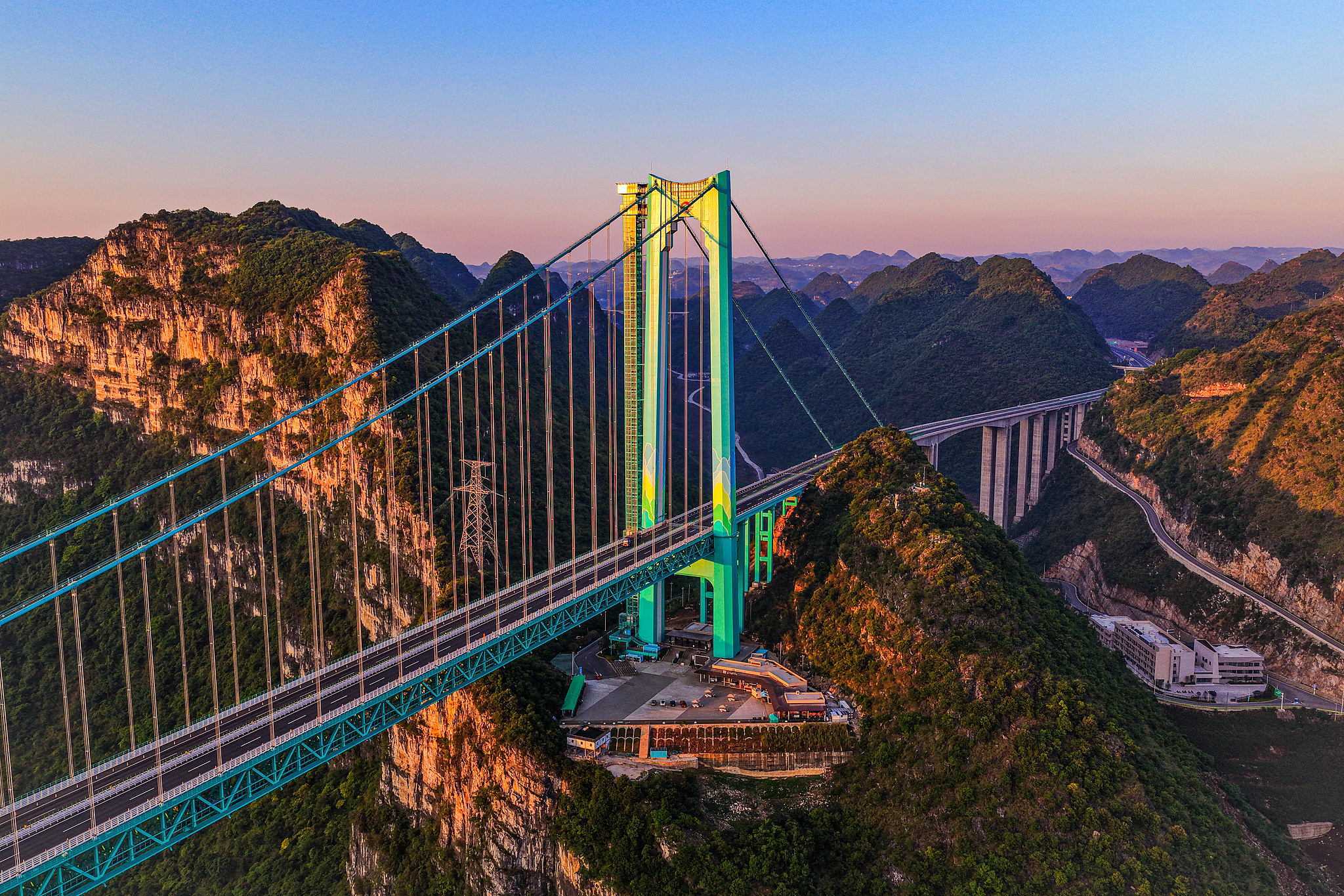 A photo taken on May 4, 2026 shows the Huajiang Grand Canyon Bridge bathed in the morning glow in Anshun, Guizhou Province. /VCG