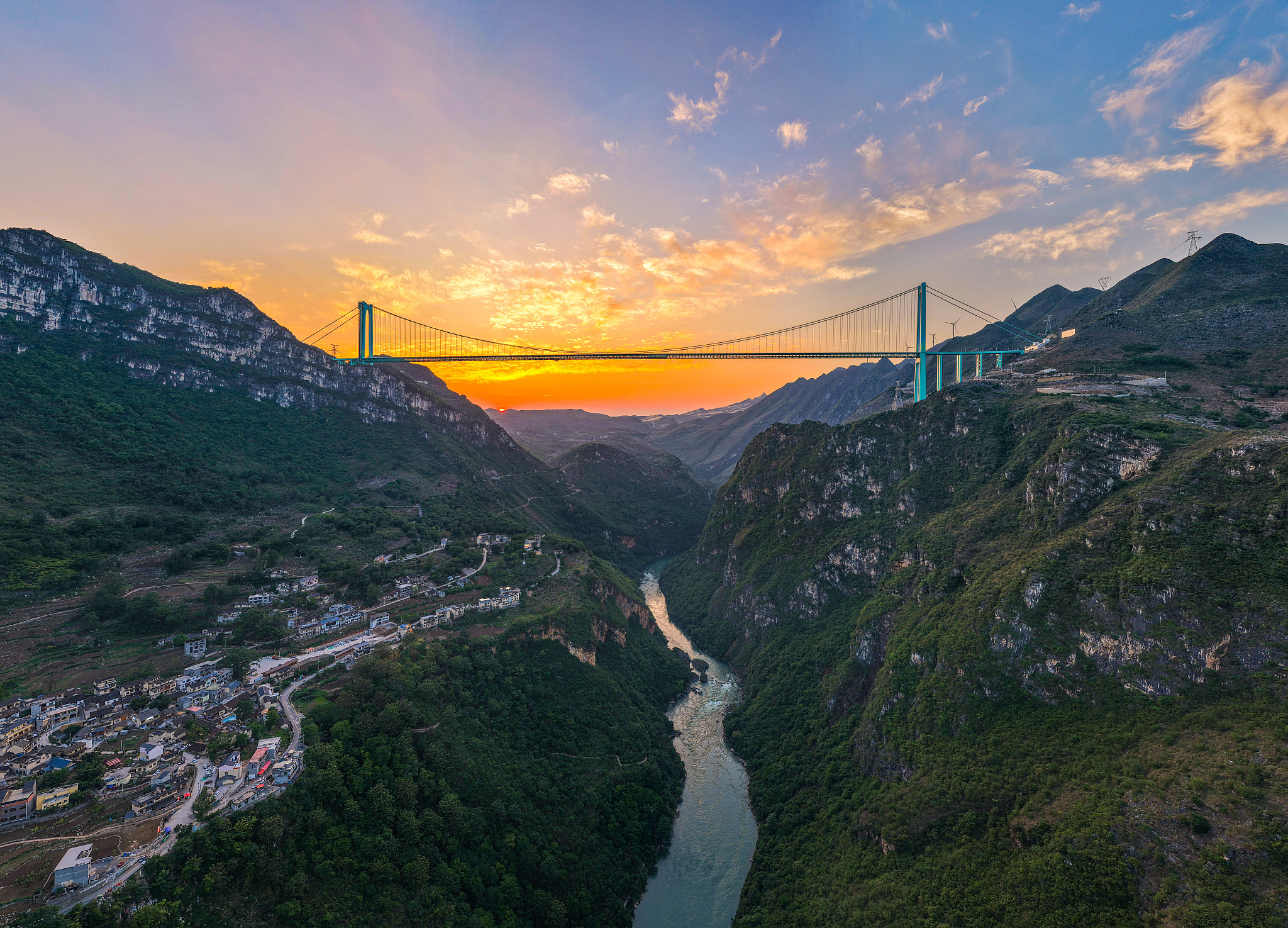 A photo taken on May 4, 2026 shows the Huajiang Grand Canyon Bridge bathed in the morning glow in Anshun, Guizhou Province. /VCG