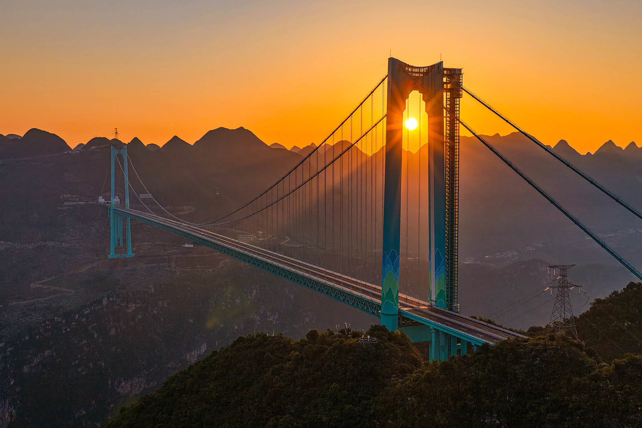 A photo taken on May 4, 2026 shows the Huajiang Grand Canyon Bridge bathed in the morning glow in Anshun, Guizhou Province. /VCG