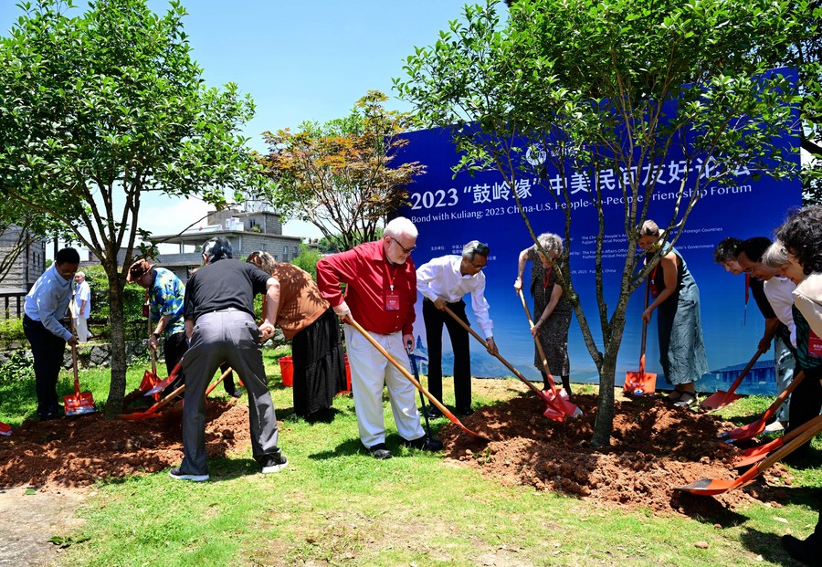 Guests attend a symposium of the Kuliang Friends plant trees in Fuzhou, southeast China's Fujian Province, June 28, 2023. /Xinhua
