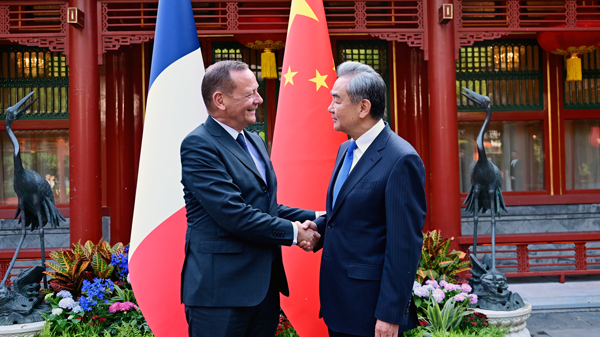 Wang Yi (R), a member of the Political Bureau of the Communist Party of China Central Committee and Chinese foreign minister, shakes hands with Emmanuel Bonne, diplomatic adviser to the French president, in Beijing, China, May 8, 2026. /Chinese Foreign Ministry