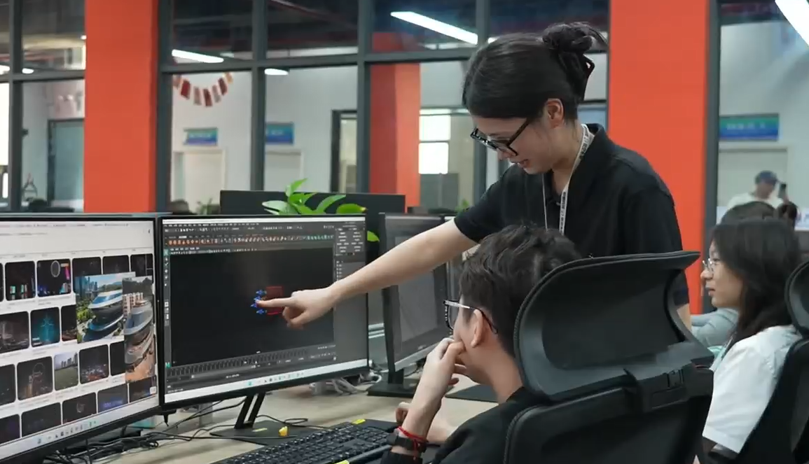 Yang Dan (C), a drone swarm flight planner, discusses work with her team in Nanning City, China's Guangxi Zhuang Autonomous Region. /CMG