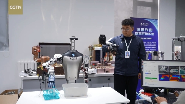 An engineer hand-trains a robot in Beijing. /CGTN