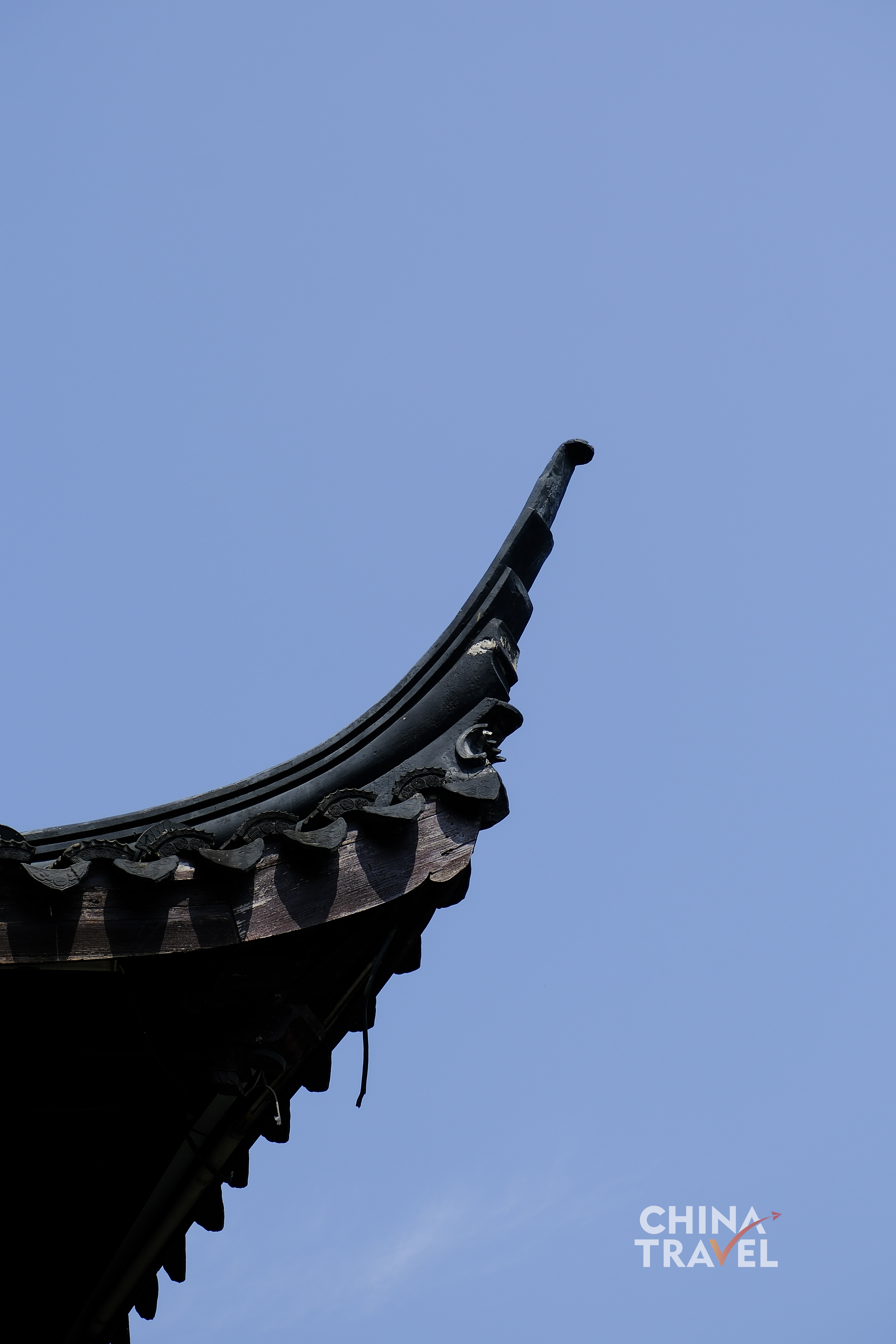 Curved ridgelines and upturned eaves form soft silhouettes against the sky, a signature gesture of Jiangnan design. /CGTN