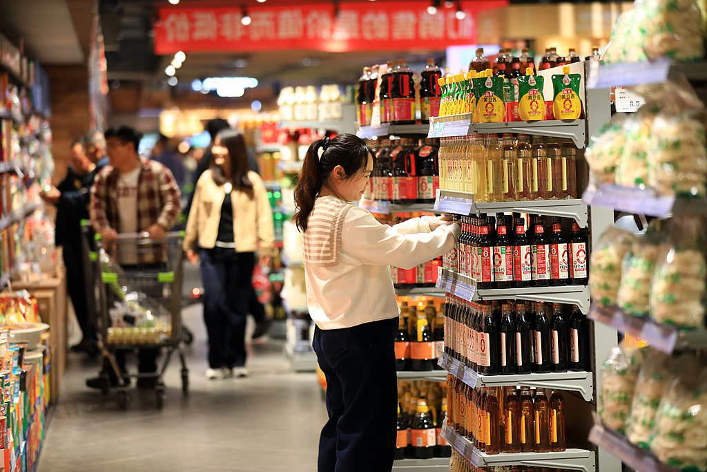 Shoppers select daily consumer goods at a supermarket stall in Jiangsu Province, China, April 18, 2026. /VCG