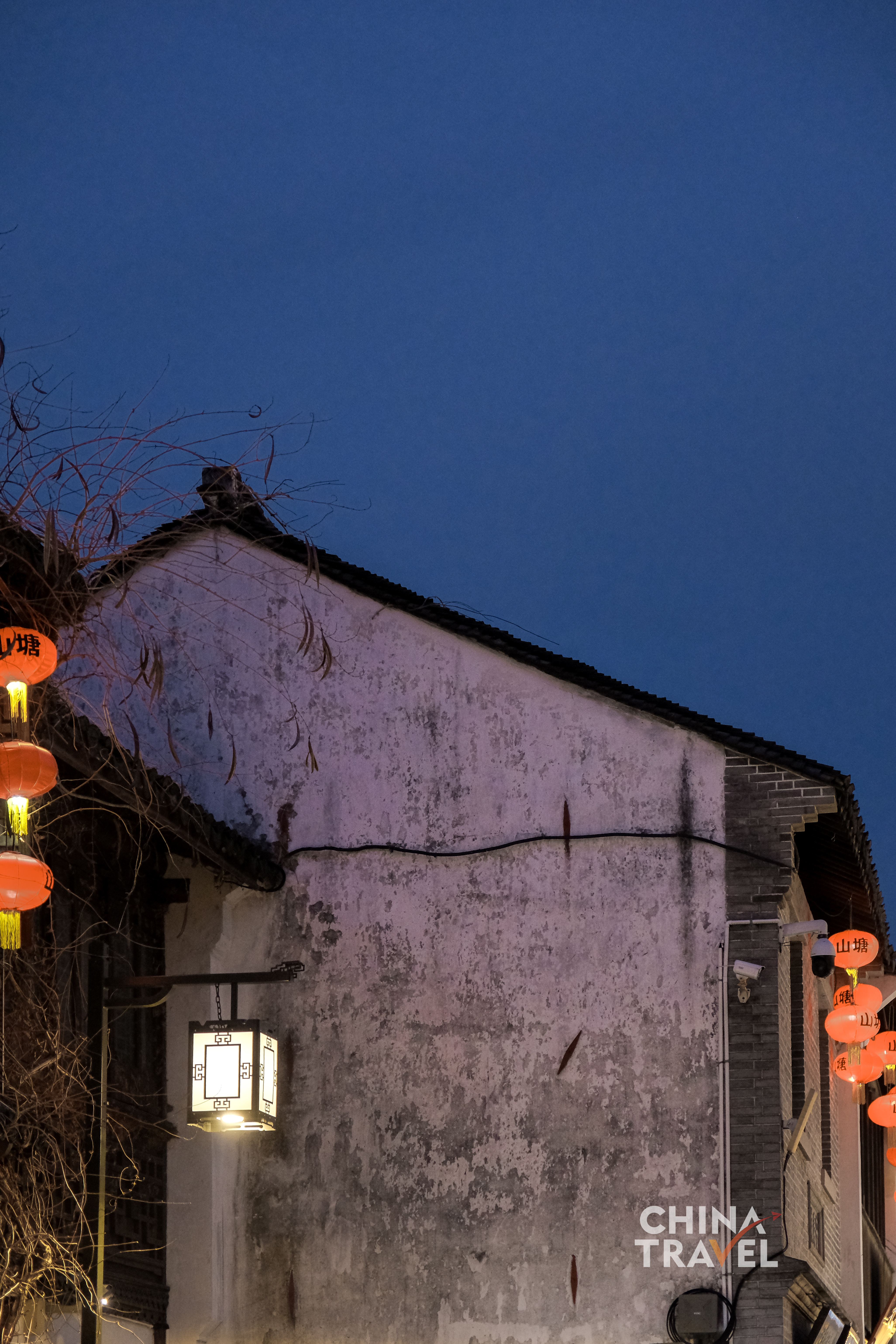 Red lanterns line the canal, casting warm light across white walls and tiled roofs along Shantang Street. /CGTN