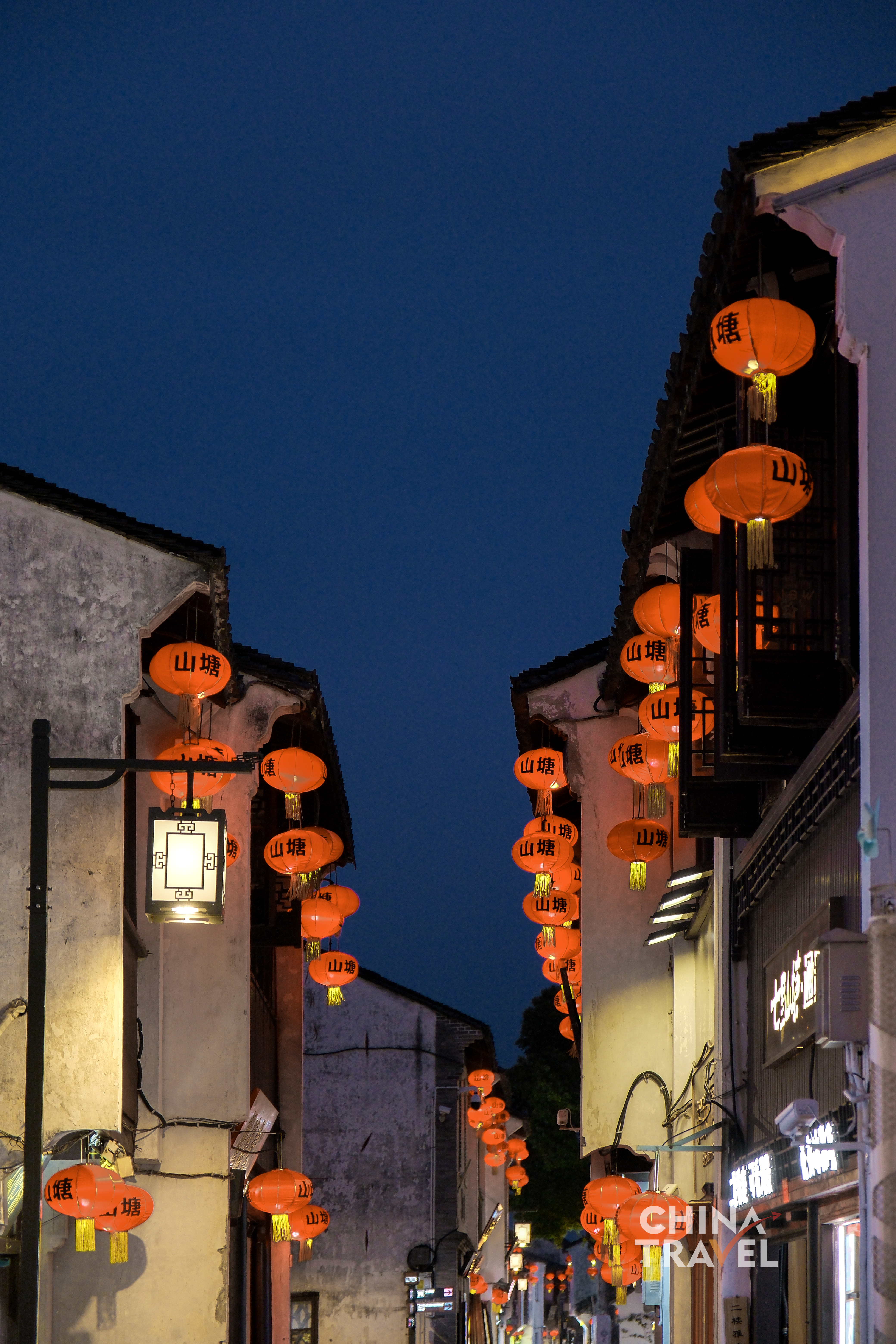 Red lanterns line the canal, casting warm light across white walls and tiled roofs along Shantang Street. /CGTN