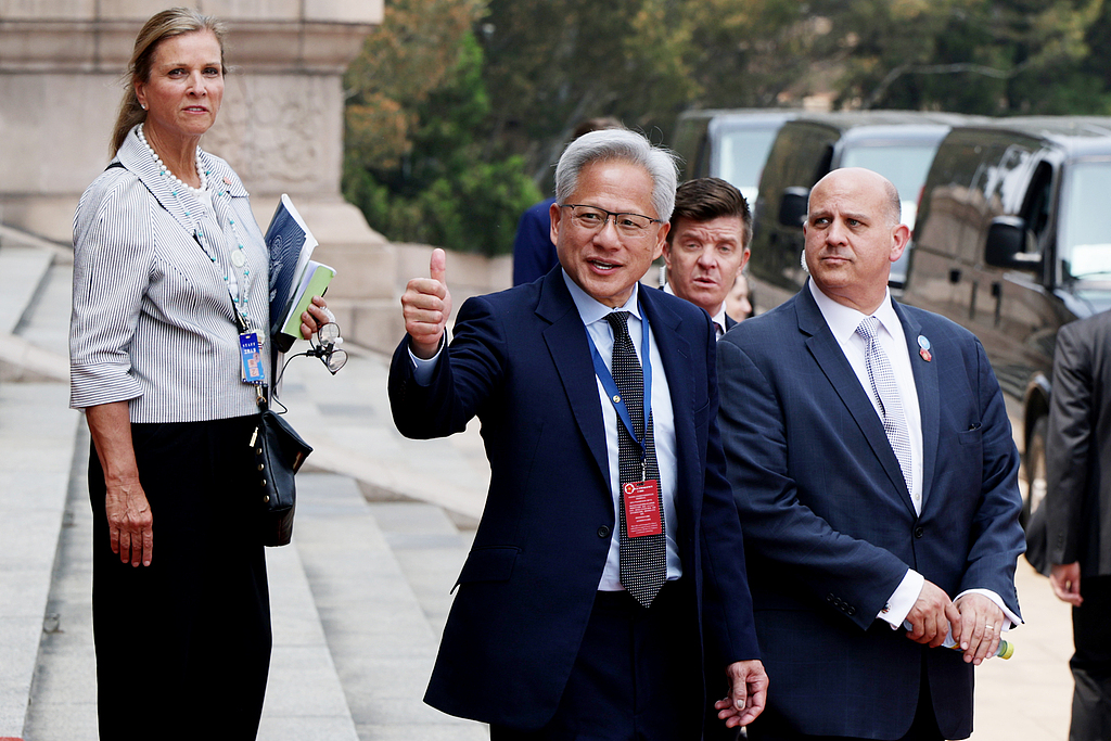Nvidia CEO Jensen Huang (C) gestures as he prepares to depart following a welcome ceremony at the Great Hall of the People in Beijing, China, May 14, 2026. /VCG