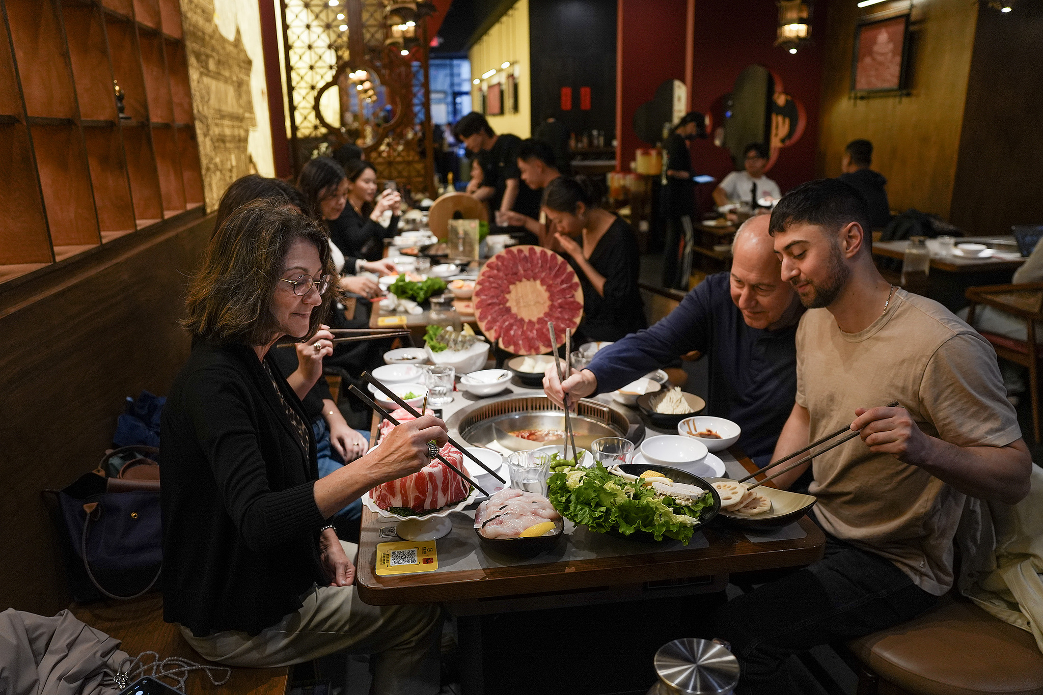 A family from Philadelphia, Pennsylvania, celebrates a birthday by enjoying Sichuan hot pot at a restaurant in New York, US, May 9, 2026. /VCG