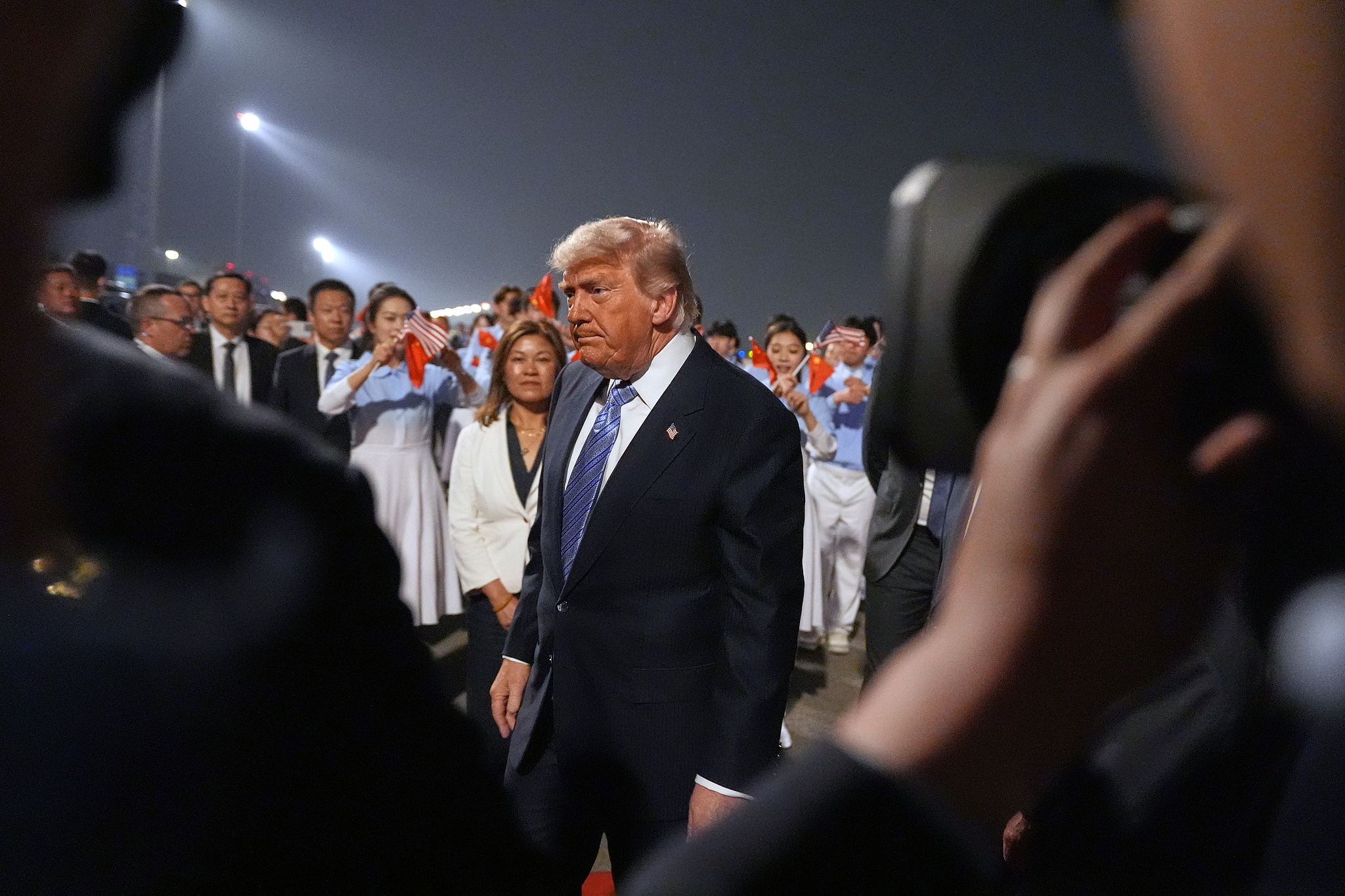 US President Donald Trump walks down the airport tarmac during his arrival ceremony at Beijing Capital International Airport in Beijing, May 13, 2026. /VCG