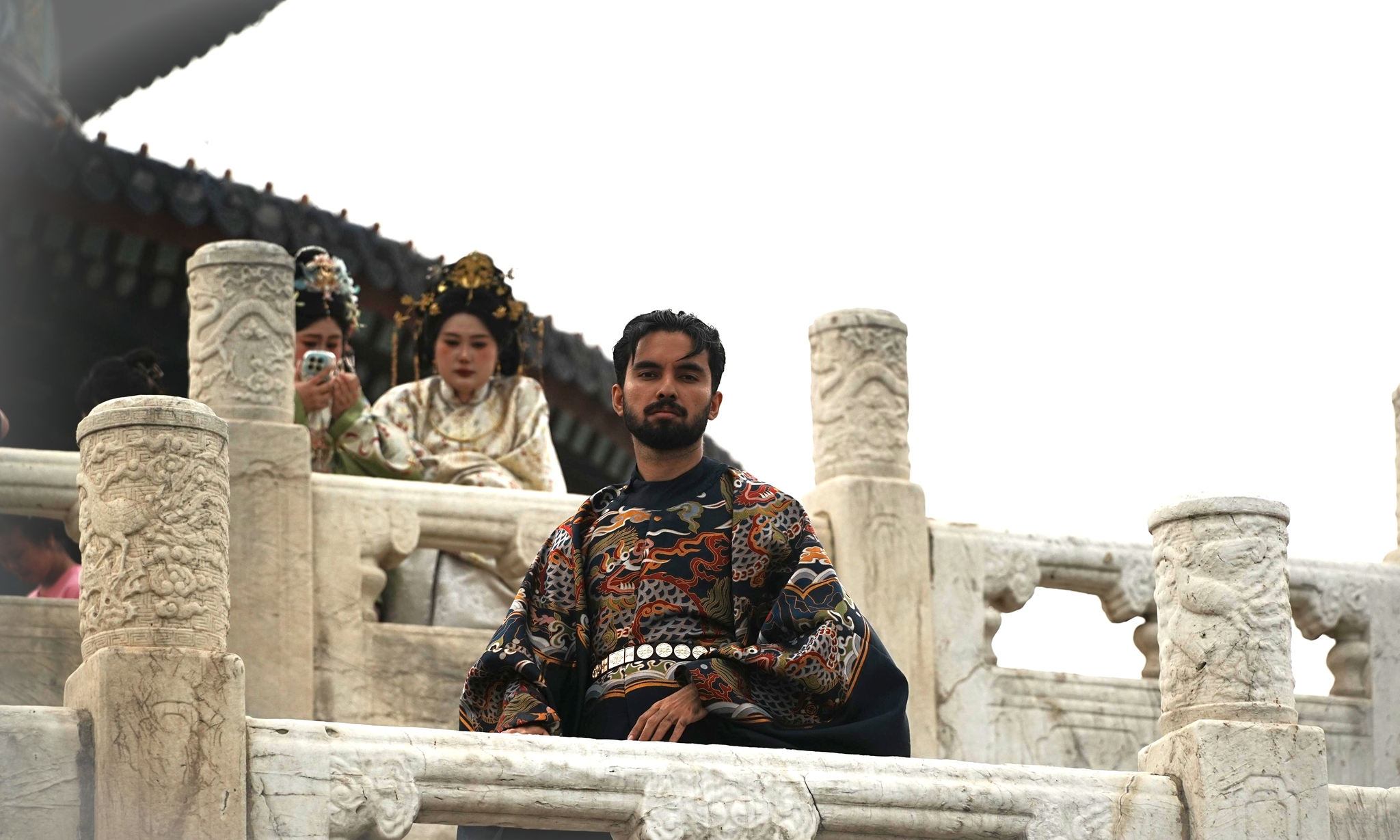 Visitors pose for photos while wearing traditional Chinese clothing at Beijing's Temple of Heaven on May 15, 2026. /VCG
