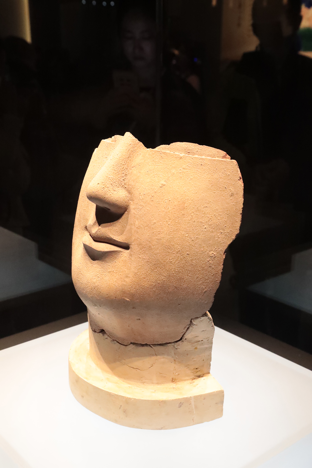 A partially preserved face of a clay Buddha statue from the Northern Wei Dynasty is on display at the Luoyang Museum in Henan Province. /CGTN