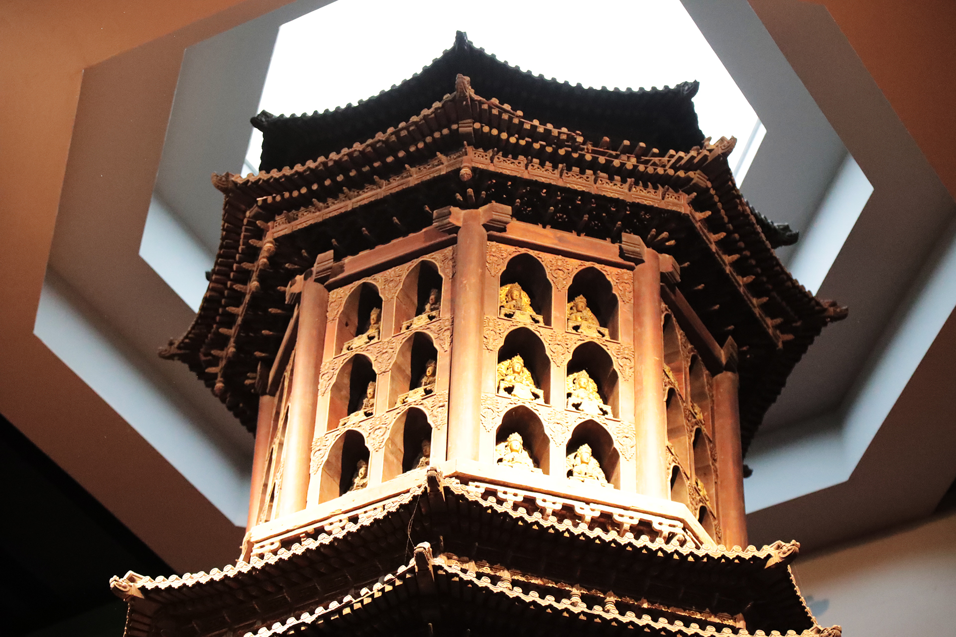 A close-up shows the Buddhist niches and gilded Buddhas of the golden nanmu pagoda at the Luoyang Museum in Henan Province. /CGTN