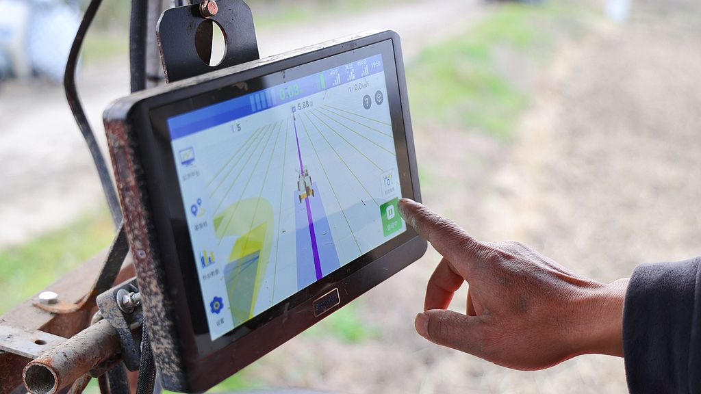 A farmer operates an agricultural machinery equipped with the BeiDou navigation system to plow wheat fields, Lianyungang City, Jiangsu Province, China, November 14, 2025. /VCG