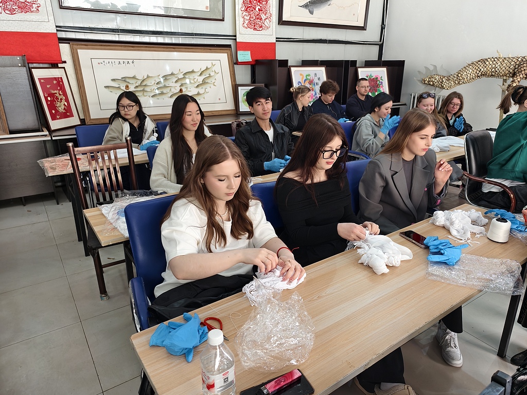 Russian international students take part in a traditional tie-dye workshop at Heihe University in Heilongjiang Province, May 12, 2025. /VCG