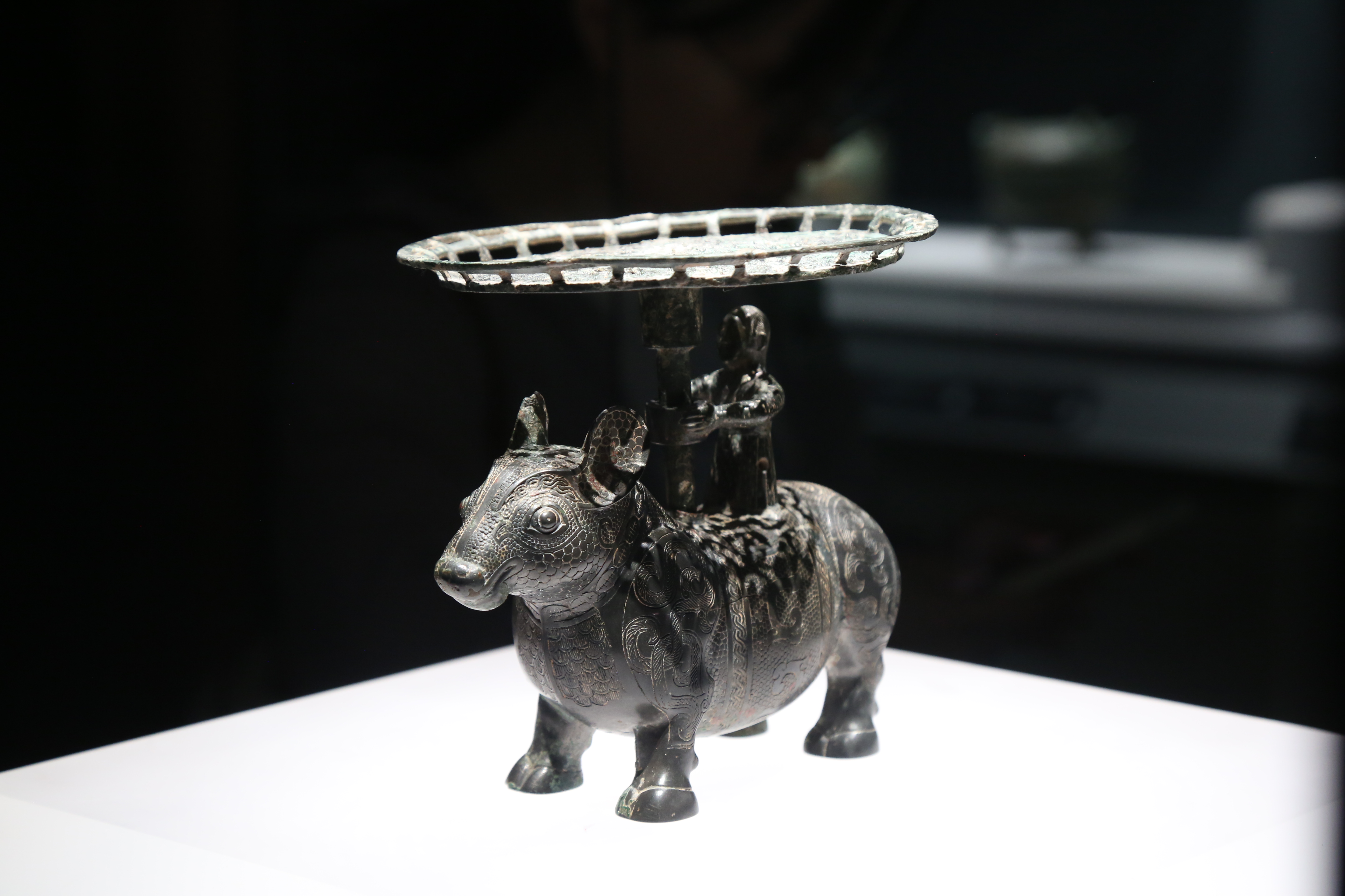Bronze ox with a man standing on the back and holding a plate, made during the Warring States Period (475 BC-221 BC), Shanxi Museum. Chen Hongyu/CGTN