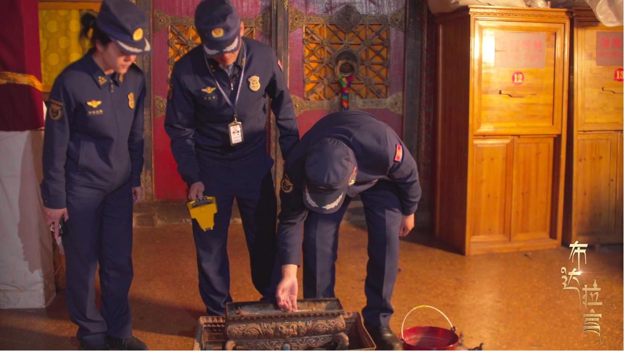 Firefighters check the temperature of incense burners after the Potala Palace has been cleared of visitors. /CGTN