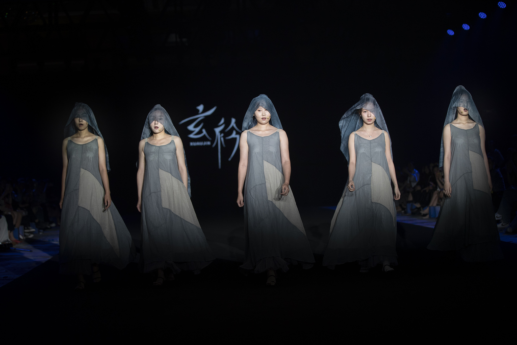 A file photo shows models displaying costumes by Chinese designer label Xuanjin. /VCG