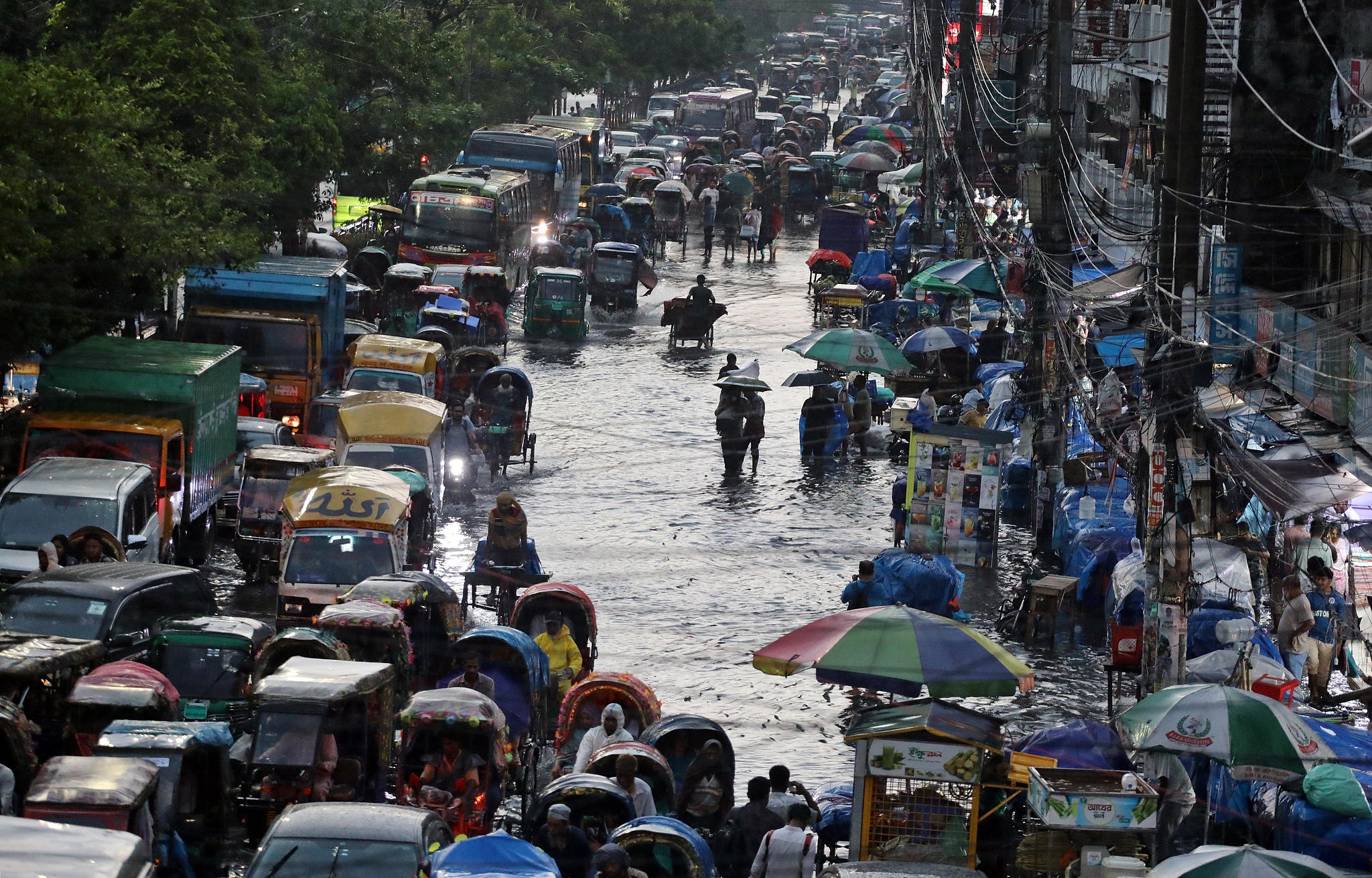 Vehicles move slowly through waterlogged streets in front of New Market in Dhaka, Bangladesh, May 13, 2026. /VCG