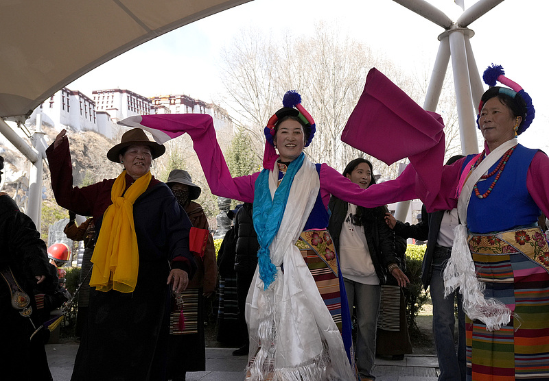 Local residents dance together at a park in Lhasa, the capital of southwest China's Xizang Autonomous Region, March 14, 2025. /CFP