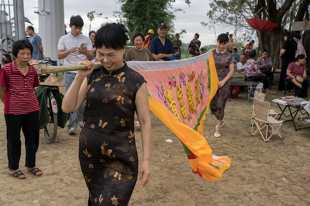 Visitors dressed in traditional qipao recreate scenes from the film 