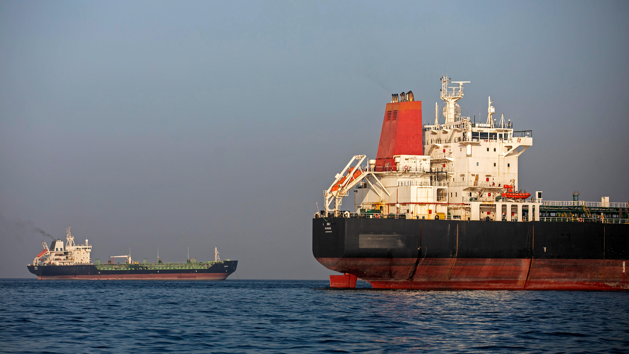 Ships remain anchored on May 16, 2026, in the Strait of Hormuz near Larak Island, Iran. /VCG