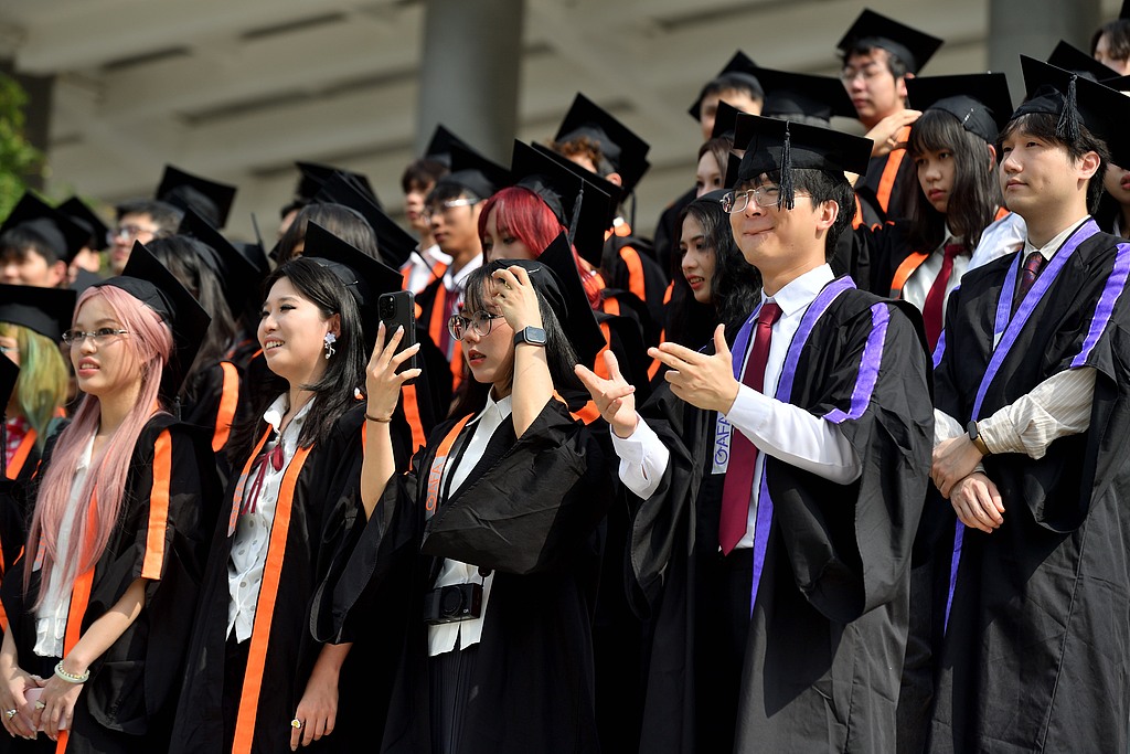Graduates from Guangzhou Academy of Fine Arts seen taking graduation photos in Guangzhou, Guangdong Province, China, May 13, 2026. /VCG