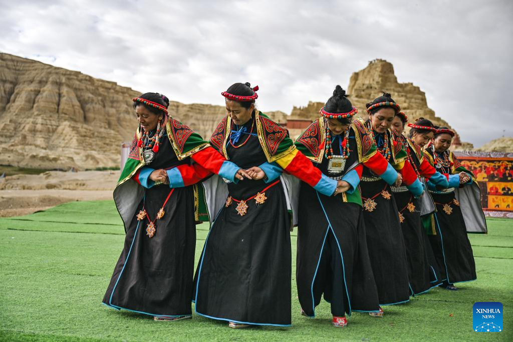 Local residents perform Xuan Dance near the ruins of the Guge Kingdom in Zanda County of Ngari Prefecture, southwest China's Xizang Autonomous Region, September 11, 2024. /Xinhua