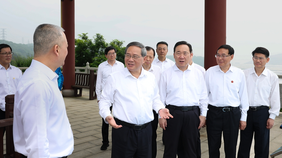 Chinese Premier Li Qiang listens to a briefing on petroleum reserve operations and learns about project construction and management in Zhoushan City, east China's Zhejiang Province, May 26, 2026. /Xinhua