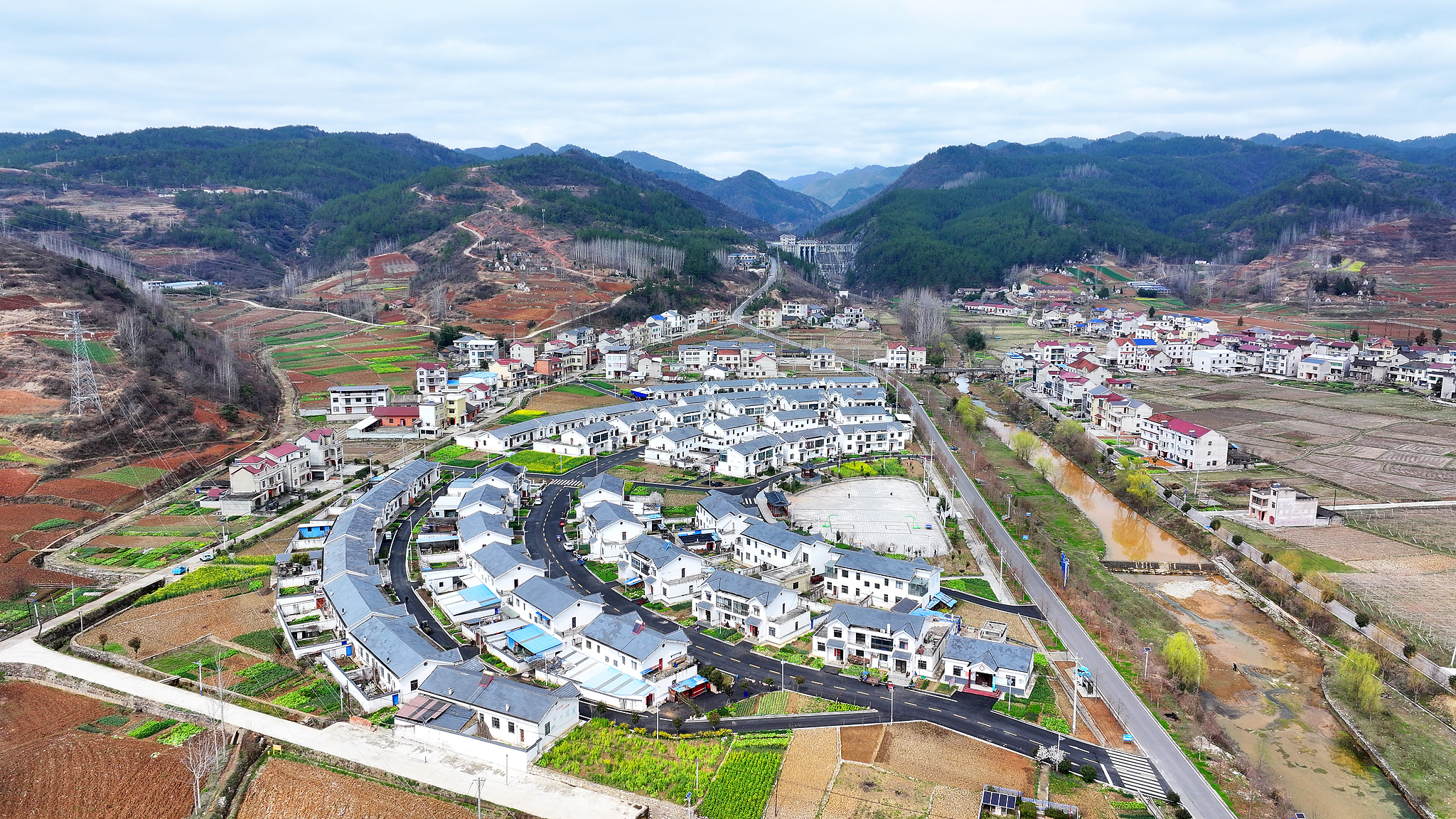 A paved asphalt road leads to households in a reservoir resettlement village in Shiyan City, central China's Hubei Province, March 8, 2026. /VCG