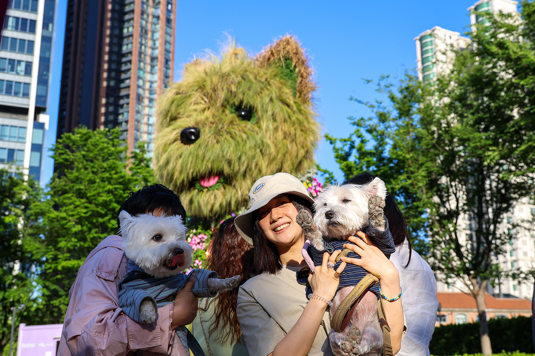 Visitors pose for photos with their pet dogs in front of the 