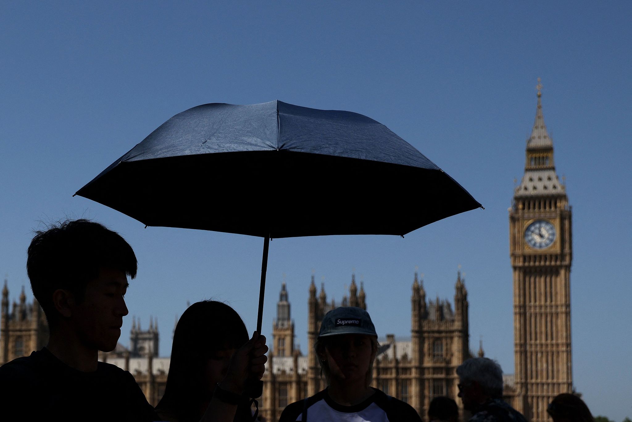Tourists shelter from the sun by 