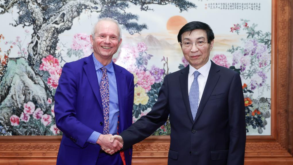 Wang Huning, a member of the Standing Committee of the Political Bureau of the Communist Party of China Central Committee and chairman of the Chinese People's Political Consultative Conference (CPPCC) National Committee, shakes hands with David Lidington, honorary president of the Great Britain-China Centre and former British minister for the Cabinet Office, Beijing, China, May 28, 2026. /Xinhua