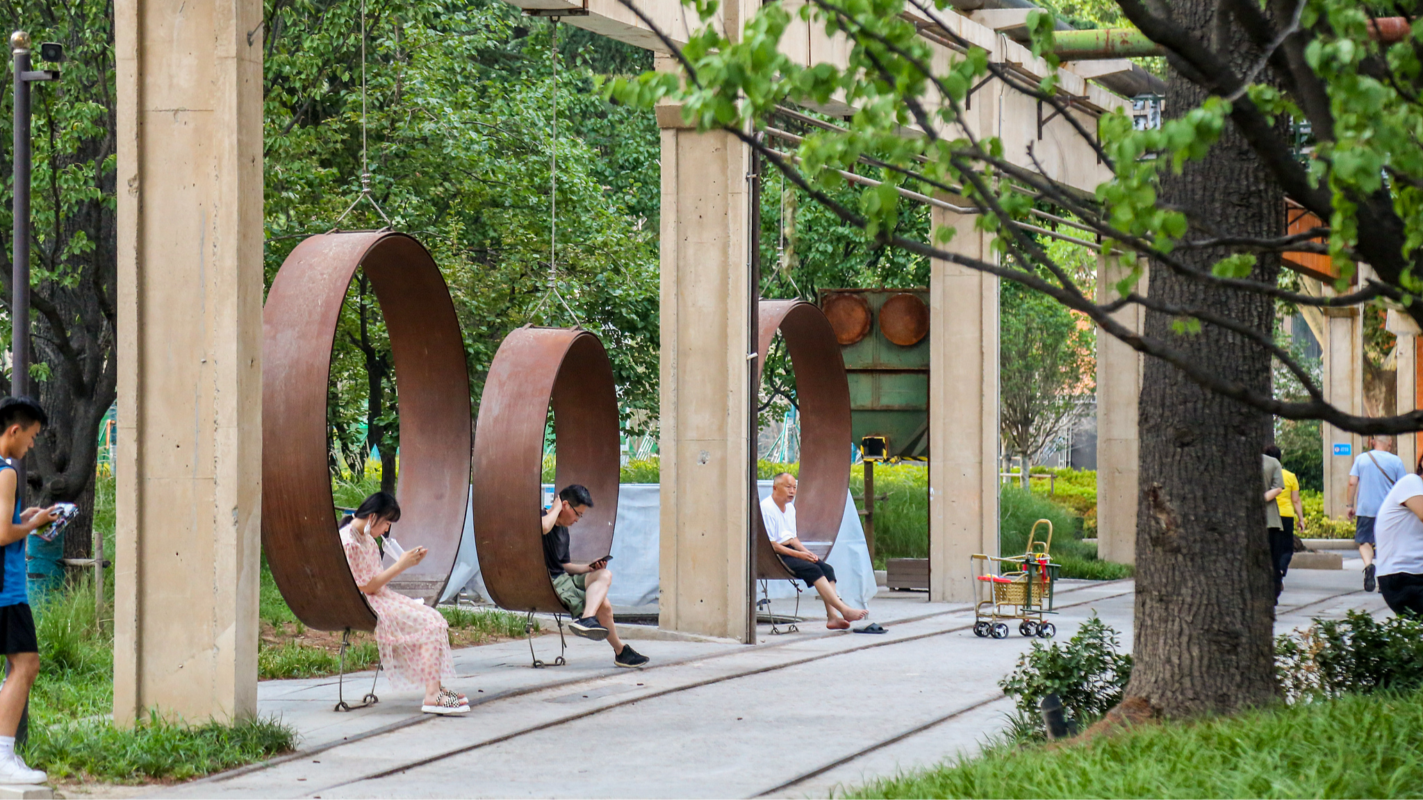 Residents relax and exercise at facilities transformed from old industrial equipment at Ersha Cultural and Creative Park in Zhengzhou, central China's Henan Province, May 14, 2026.