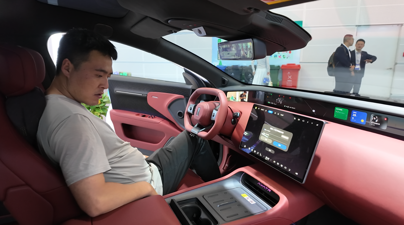 A visitor experiences the smart cockpit of an Avatr 12 at the 2026 WIE Chongqing Pavilion, Tianjin, China, May 28, 2026. /UpGuizhou