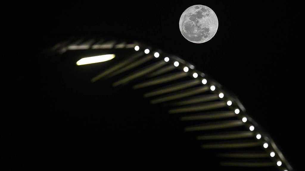 A full moon rises over Doha Corniche in Doha, Qatar, May 31, 2026. 