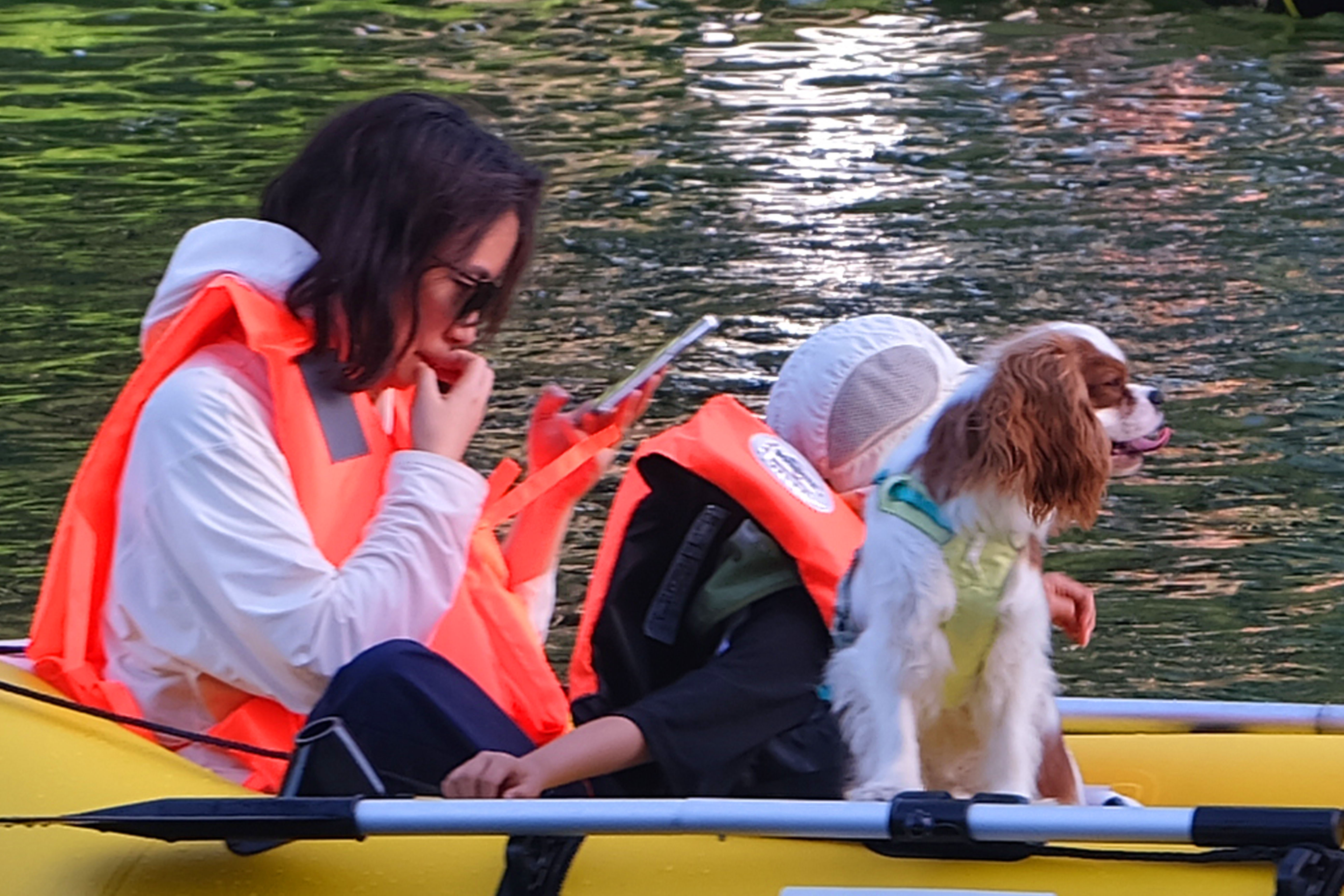 A woman and her pet relax on the water at the Liangma River International Waterfront, a popular summer leisure destination in Beijing, on June 1, 2026. /IC