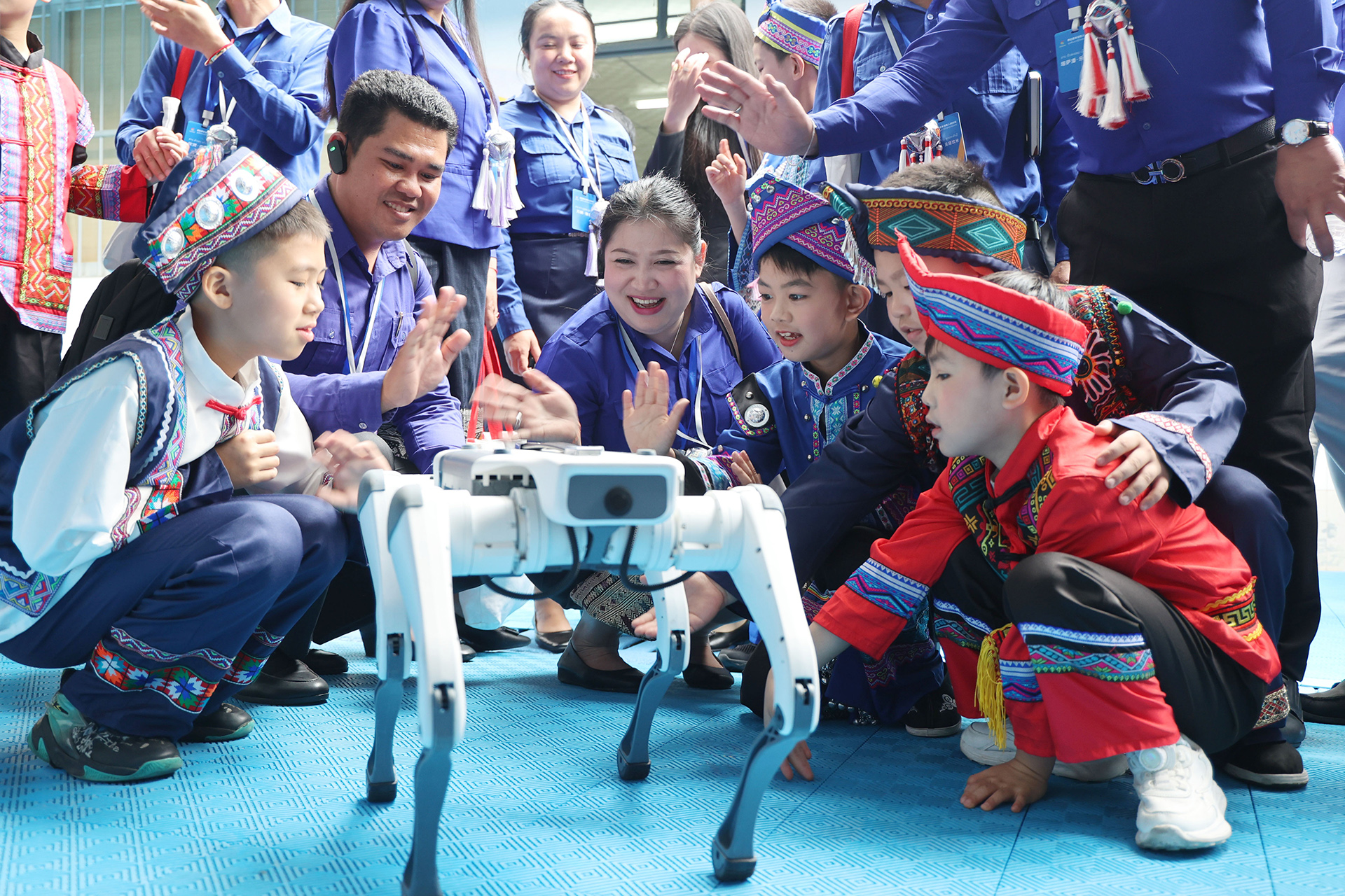 Young representatives from Laos interact with a robot dog during a visit to a youth center in Nanning, Guangxi Zhuang Autonomous Region on March 22, 2026. /IC