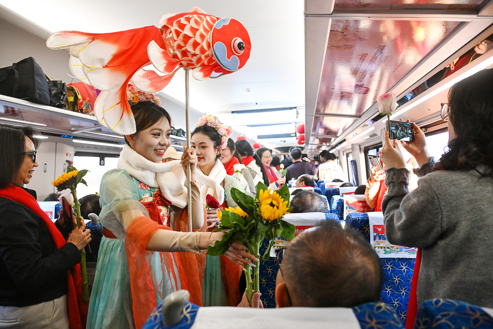 Performers interact with passengers during the 