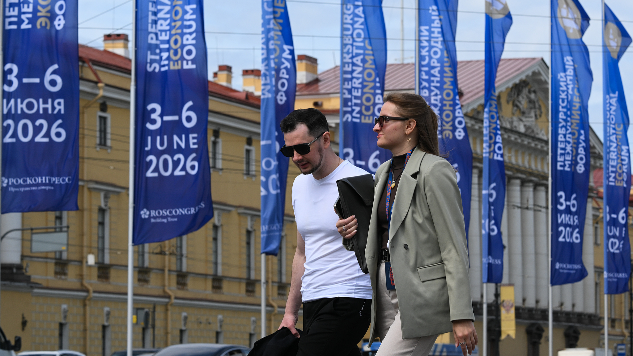 People walk past flags with the logo of the St. Petersburg International Economic Forum (SPIEF) installed in the Palace Square, in St. Petersburg, Russia, June 2, 2026. /CFP