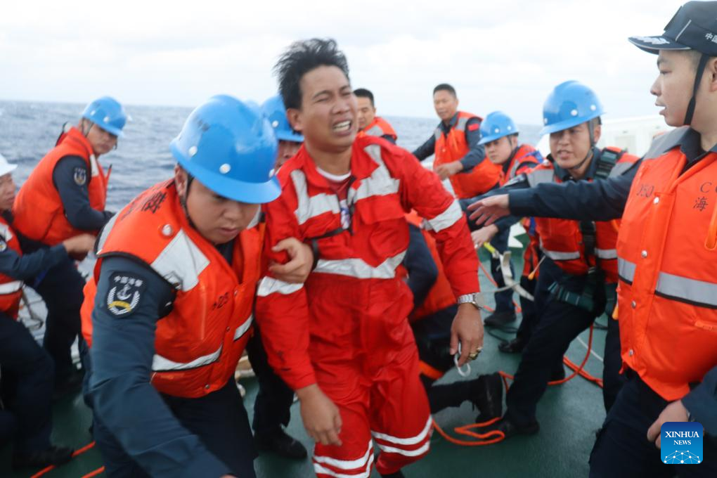 Members of the China Coast Guard rescue a Filipino crew member after a foreign cargo ship capsized in the territorial waters of south China's Huangyan Dao, January 23, 2026. /Xinhua