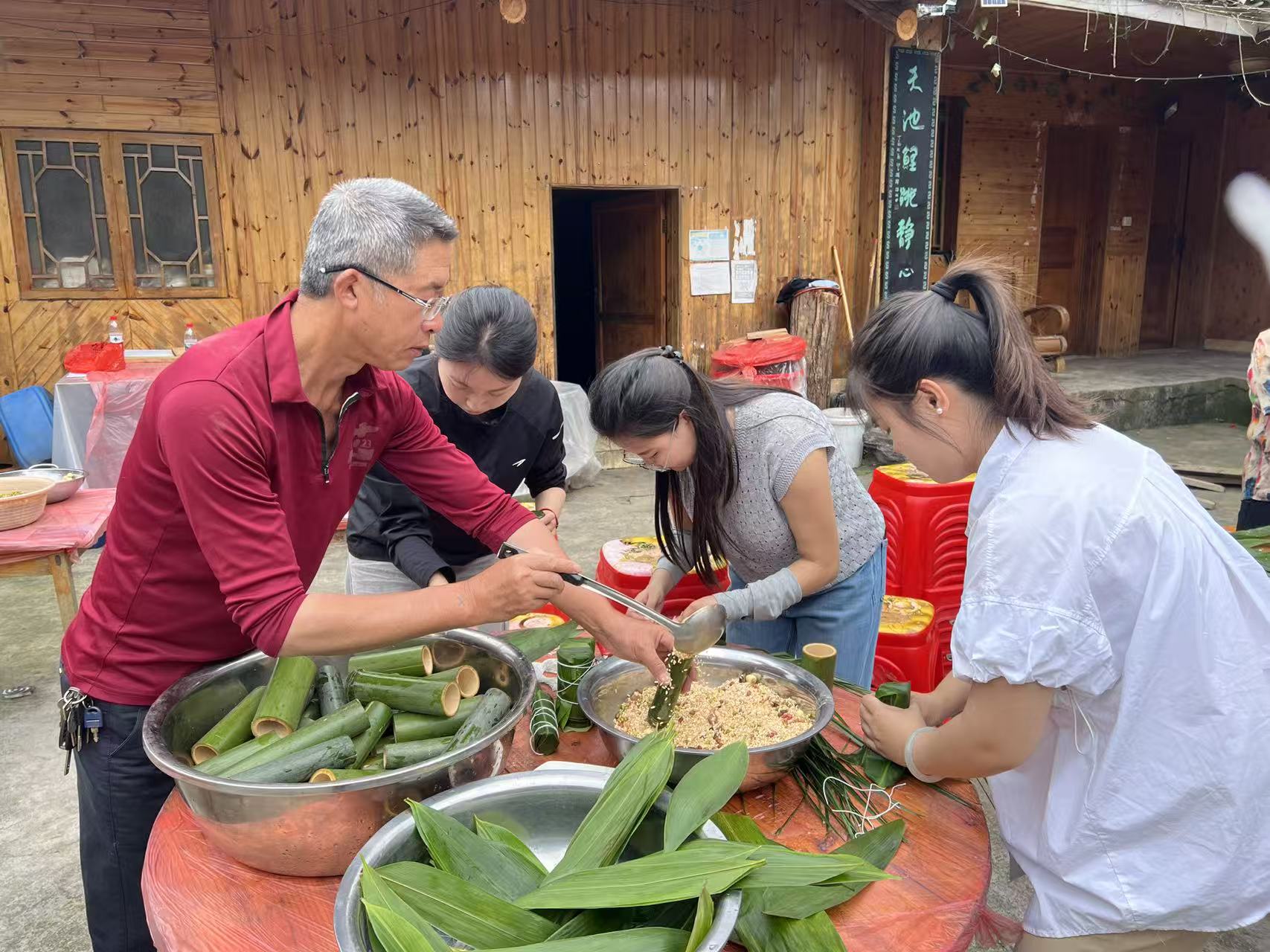 People make bamboo-tube zongzi in Liulongshan of Tongren, southwest China's Guizhou Province on June 1, 2026. /Tongren Media Convergence Center