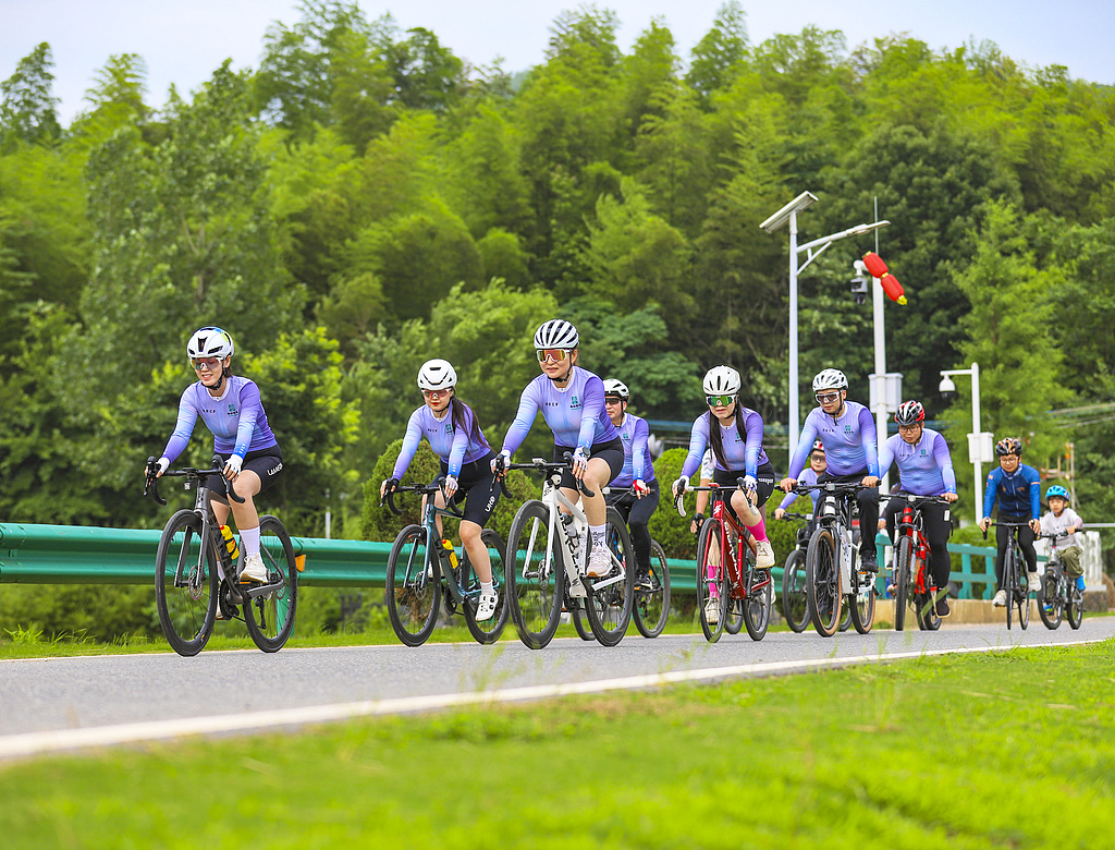 Cycling enthusiasts ride along a rural road, enjoying a low-carbon lifestyle in Dongdao Village, Wuhu City in southeastern China's Anhui Province, June 6, 2026. /CFP