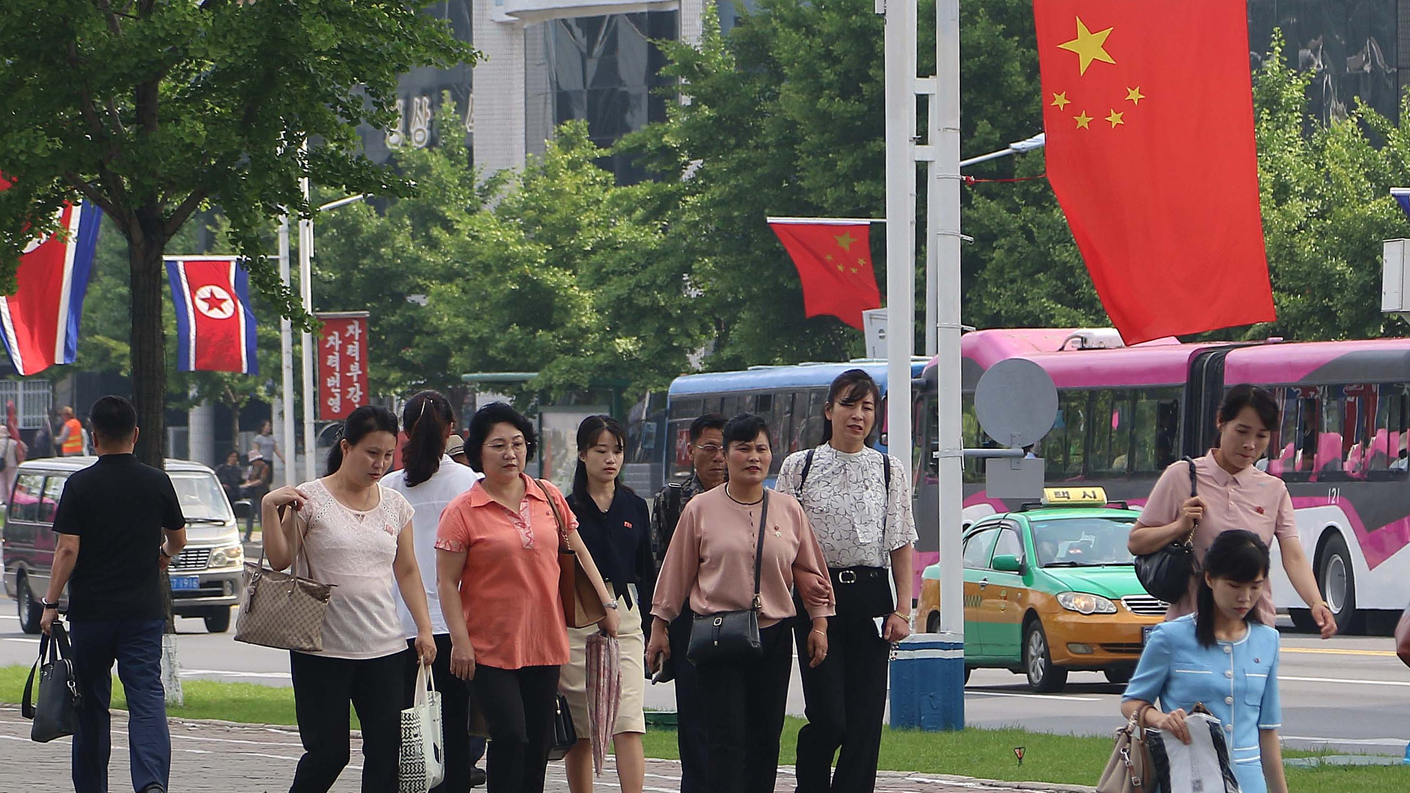 People walk under the flags of China and the Democratic People's Republic of Korea, on Changjon Street in Pyongyang, June 8, 2026. /CFP