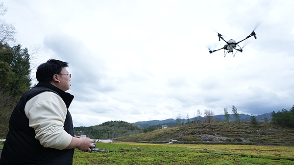 A farmer operates a drone to weed fields ahead of the spring farming season, Chongqing, China, March 30, 2026. /VCG